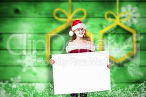 Composite image of festive redhead in foam beard holding poster
