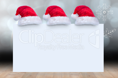 Composite image of santa hat on poster