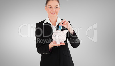 Composite image of charming woman in suit inserting a money bill