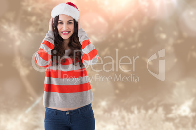 Composite image of festive brunette smiling at camera Composite image of festive brunette smiling at camera