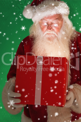 Composite image of father christmas opening a magical christmas