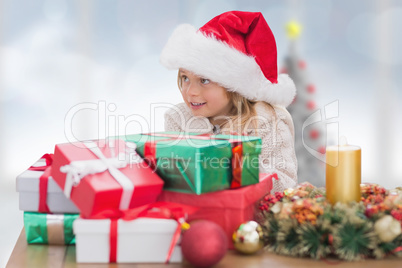 Composite image of cute little girl with gifts