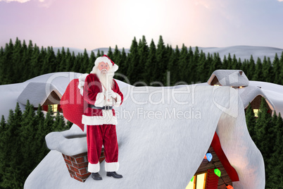 Composite image of santa on cottage roof