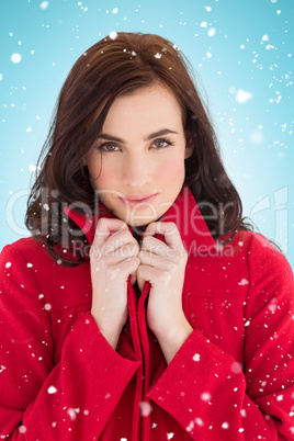 Composite image of portrait of a stylish brunette in red coat