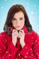Composite image of portrait of a stylish brunette in red coat