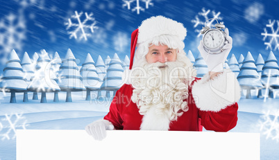 Composite image of santa claus holding alarm clock and sign