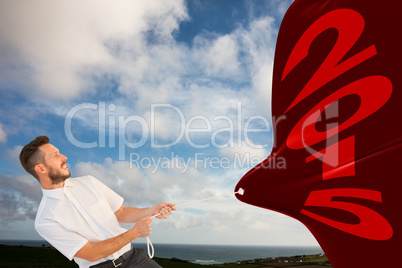 Composite image of hipster businessman pulling a rope