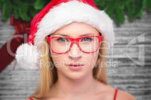 Composite image of festive blonde wearing hipster glasses