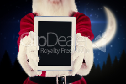 Composite image of santa presents a tablet pc