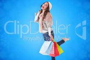 Composite image of excited brunette posing with shopping bag