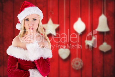 Composite image of festive blonde keeping a secret