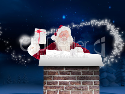 Composite image of santa shows a present while holding sign