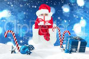 Composite image of festive woman holding gift