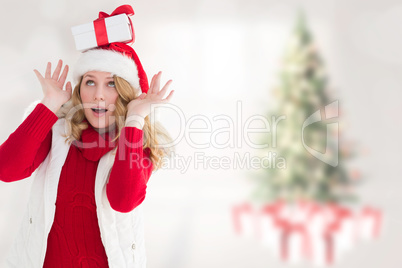 Composite image of smiling santa young woman with gift on her he