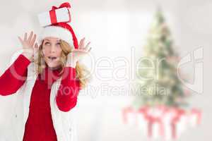 Composite image of smiling santa young woman with gift on her he