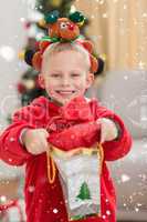 Composite image of festive little boy smiling at camera with gift