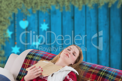 Composite image of woman asleep on couch