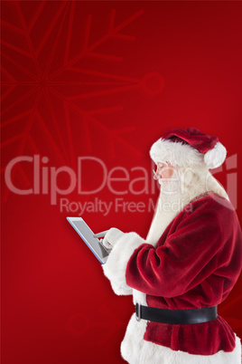 Composite image of santa uses a tablet pc