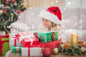 Composite image of cute little girl surrounded by christmas gift