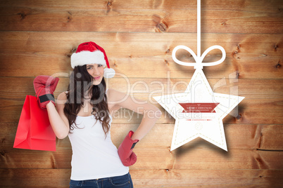 Composite image of beauty brunette in boxing gloves with shoppin