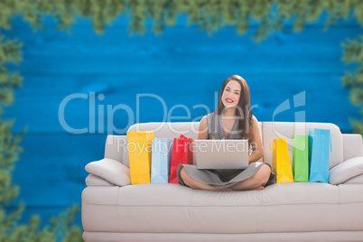 Composite image of woman smiling with laptop