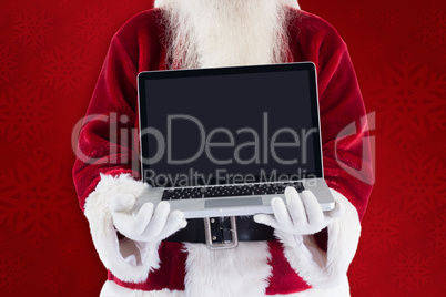 Composite image of santa claus presents a laptop