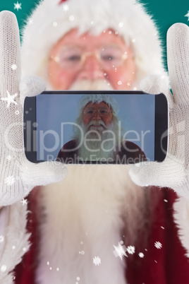 Composite image of santa records himself with a smartphone