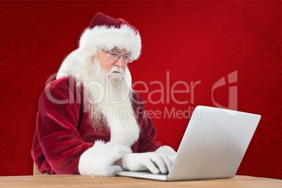 Composite image of santa surfs on the internet