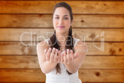 Composite image of cheerful blonde holding hands out