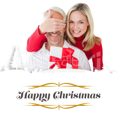 Composite image of smiling woman covering partners eyes and hold