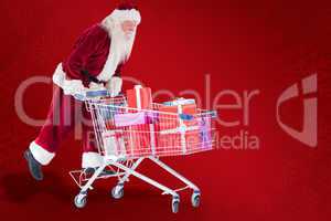 Composite image of santa rides on a shopping cart