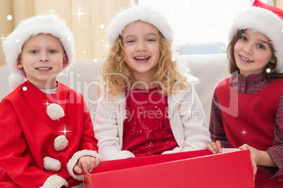 Composite image of festive little siblings smiling at camera