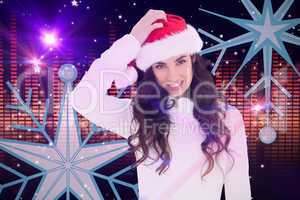 Composite image of confused brunette in santa hat