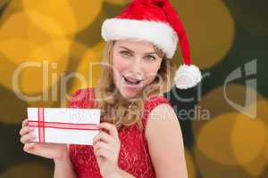 Composite image of woman smiling with present in hands