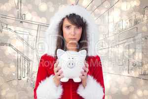 Composite image of sad festive woman holding a piggy bank in her