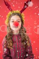 Composite image of festive little girl wearing red nose