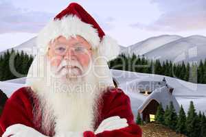 Composite image of santa smiles with folded arms