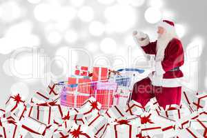 Composite image of santa delivering gifts from cart