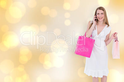 Composite image of happy blonde holding shopping bags and talkin