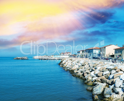 Rocks over the oceans. Beautiful seascape with village homes at