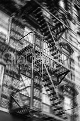 Motion blurred image of New York brick buildings with outside fi