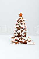 The hand-made eatable gingerbread New Year Tree with snow decora