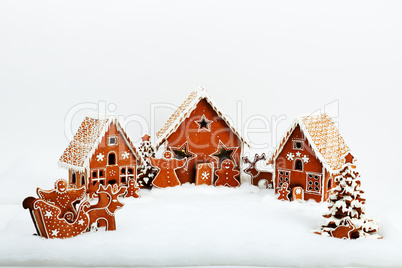 The family near hand-made eatable gingerbread house and New Year