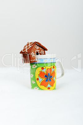 The hand-made eatable gingerbread houses on a cup and snow decor