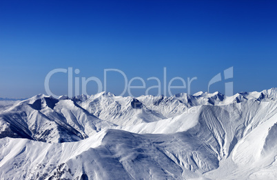 Winter snowy mountains with avalanche slope at evening