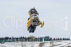 High jump of sportsman on snowmobile