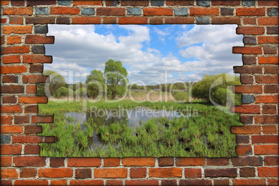 broken brick wall and view to spring