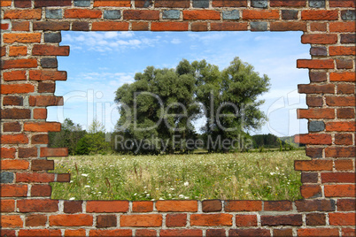 broken brick wall and view to summer landscape