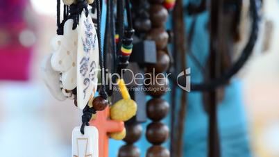 Hippies and tribal necklaces hanging in stall hawking crafts