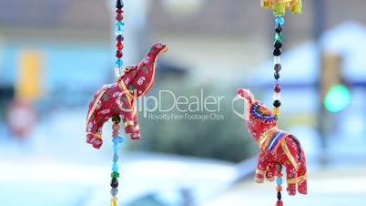 Red Indian elephants hanging in hawker stall craft